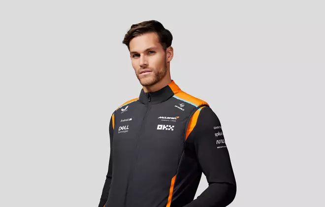 A male model wearing F1 teamwear jacket